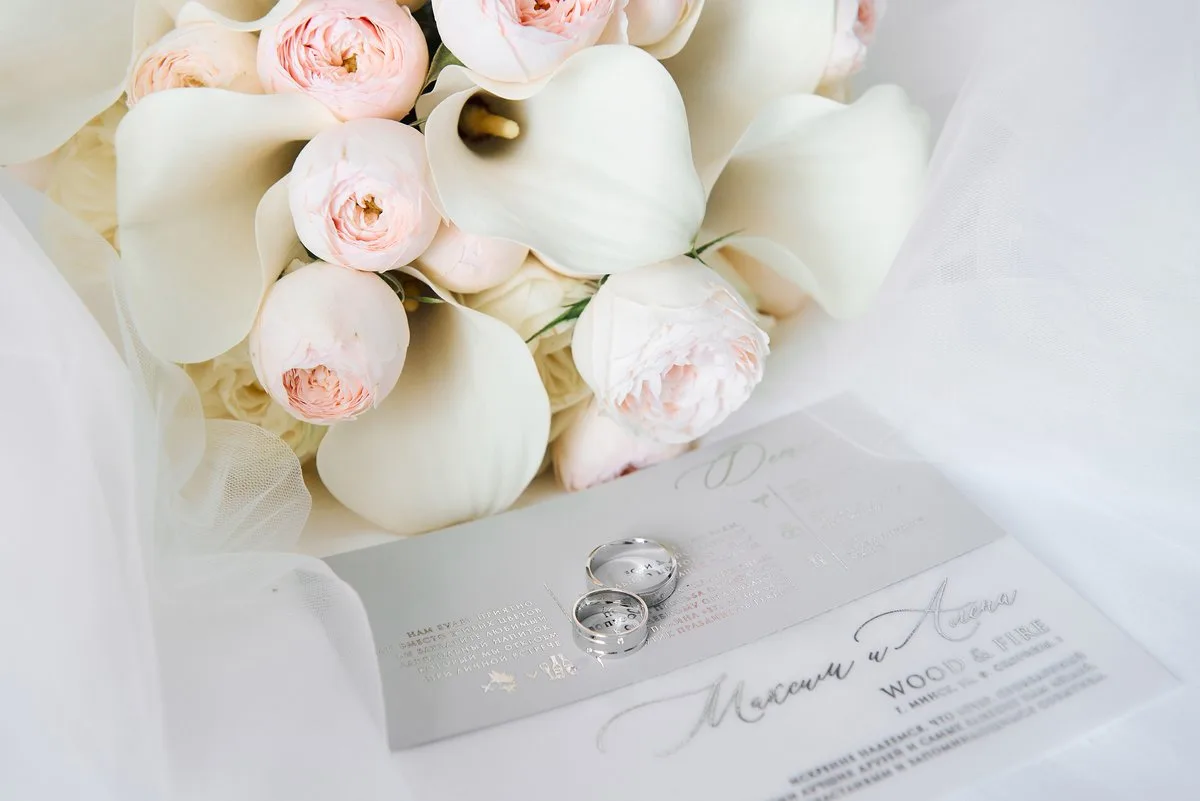 Wedding stationery and rings on elegant surface