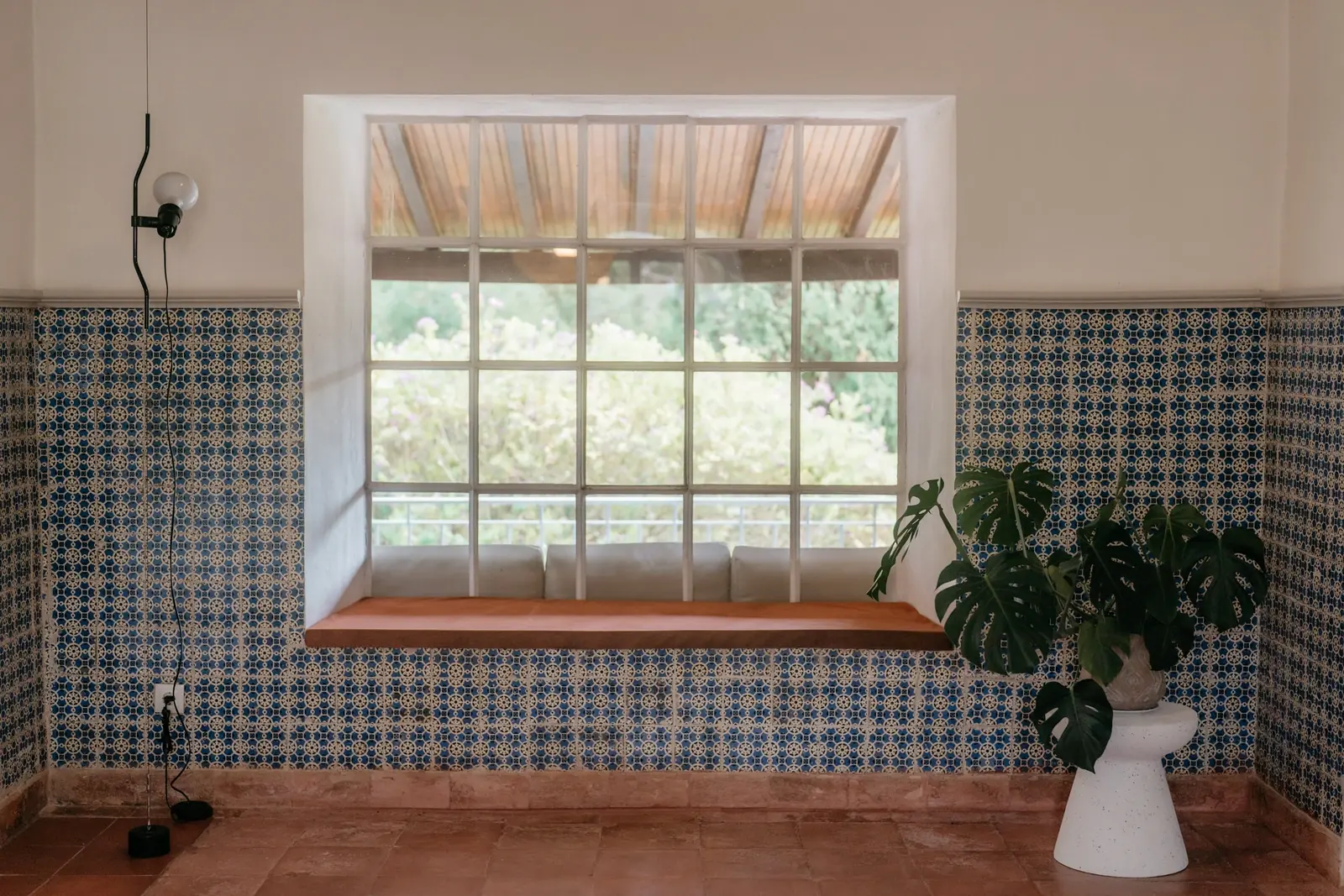 Azulejo half-walls and terracotta floor at Casa Sacoto near Lisbon