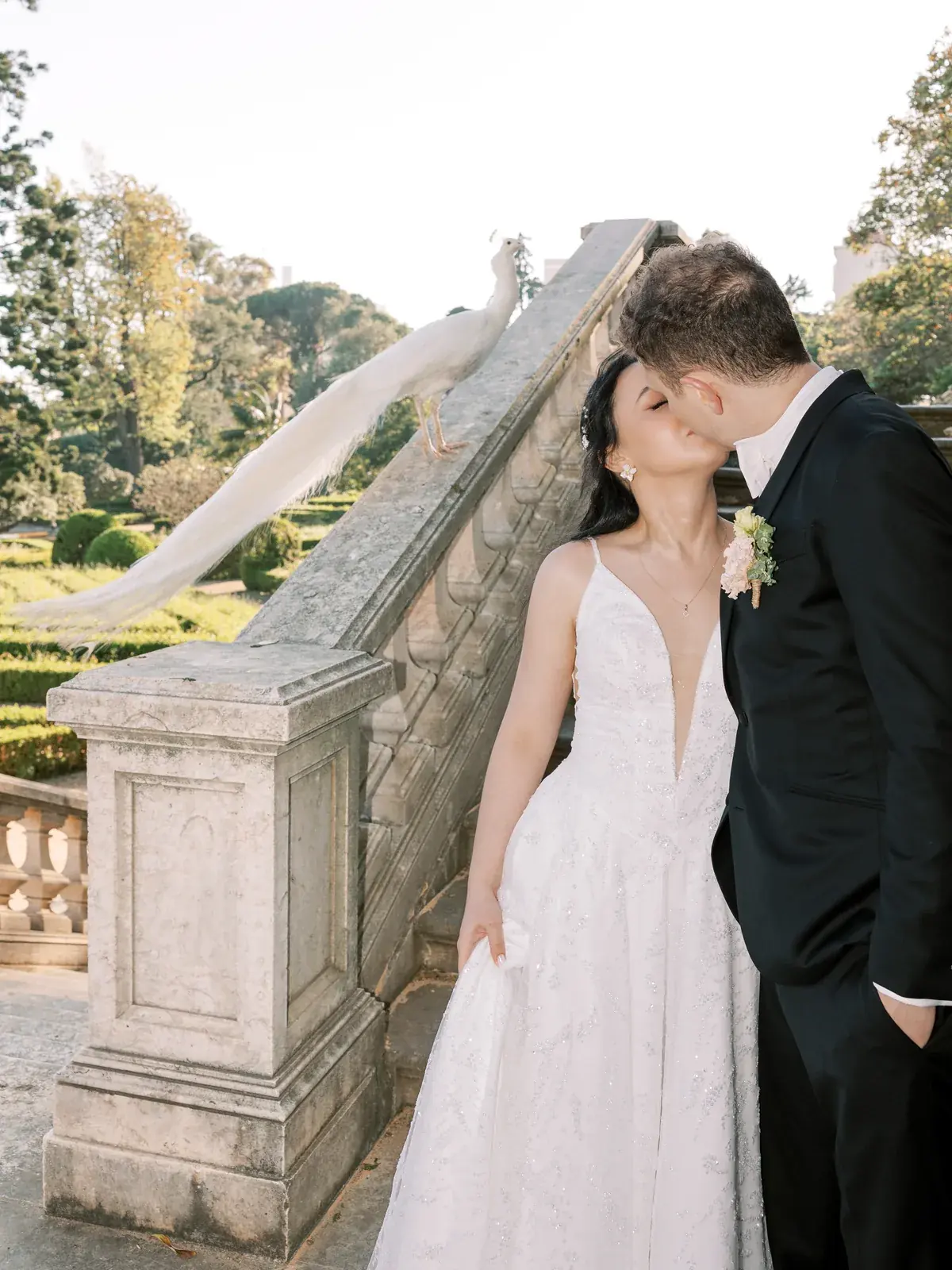 Couple with calla lily bouquet, bride in lace halter-neck dress