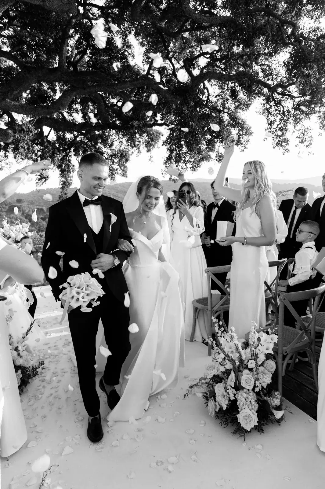 Black and white bride ascending grand palace staircase with floral arch