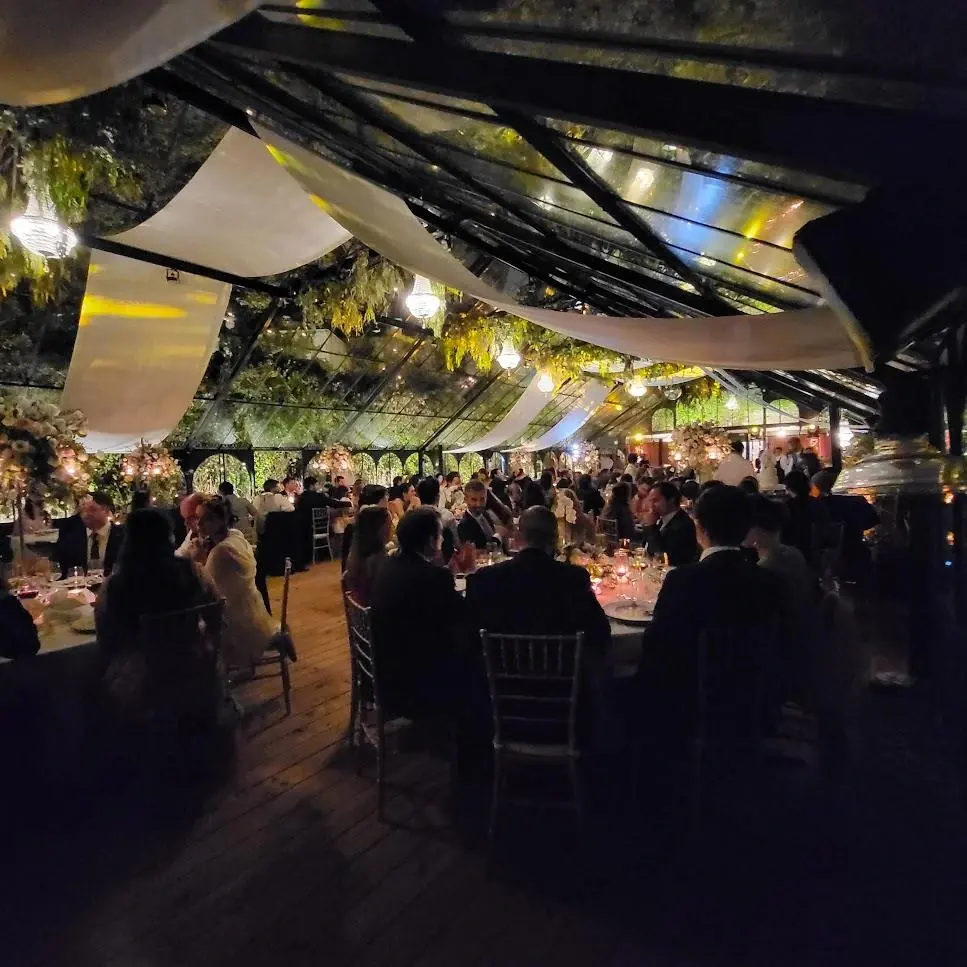 Daytime celebration in the Victorian greenhouse at Quinta da Bella Vista with draped long tables