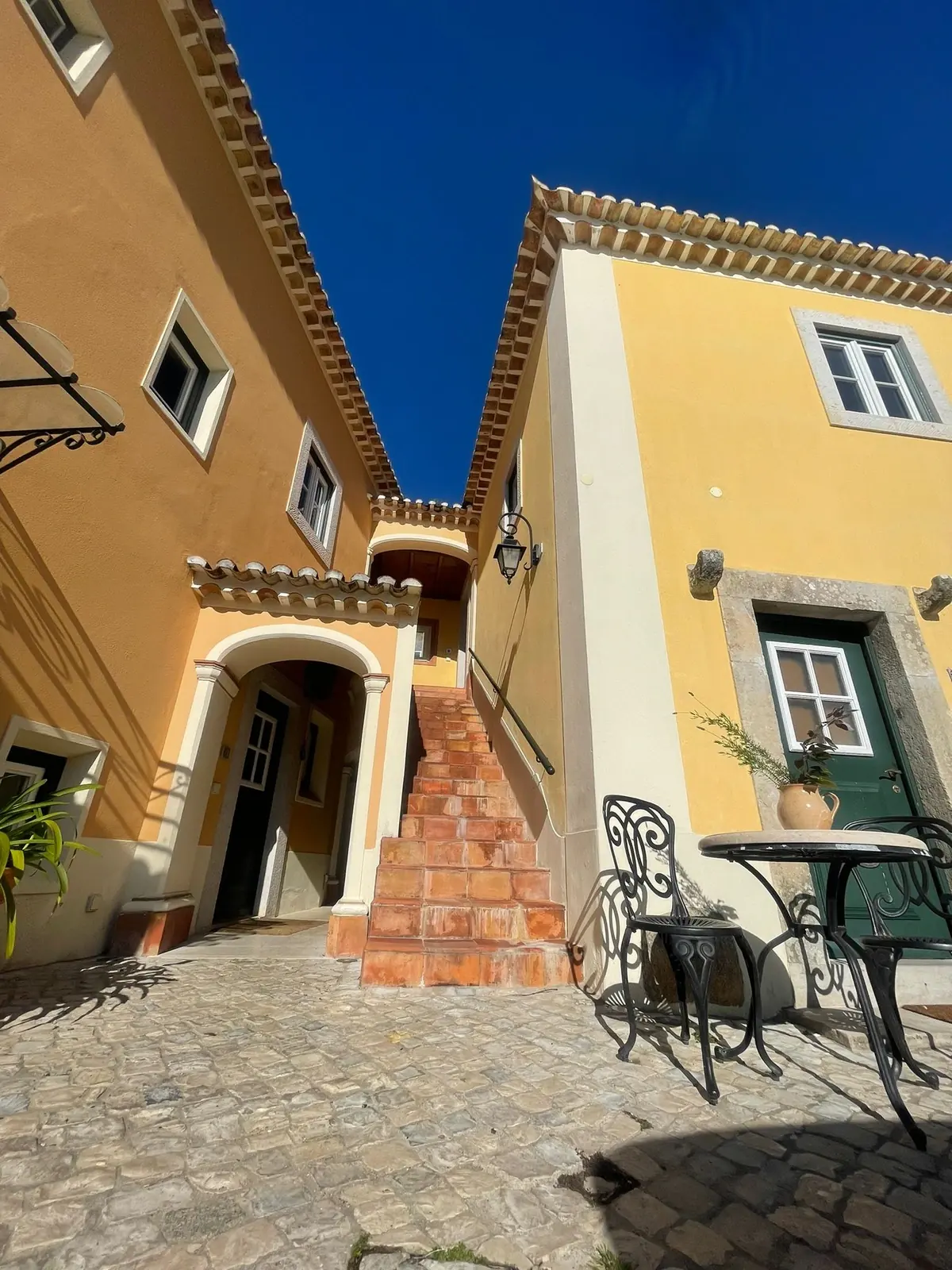 Villa courtyard at Quinta da Bella Vista with arched entrance and patio